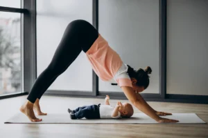 Woman doing yoga while holding her baby