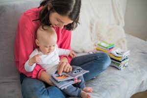 Mother reading a book with her baby