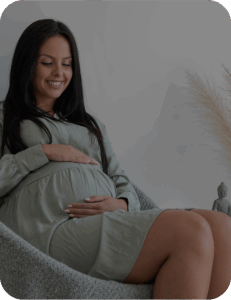 pregnant woman holding her tummy, smiling