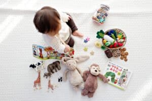 Baby playing with multiple toys